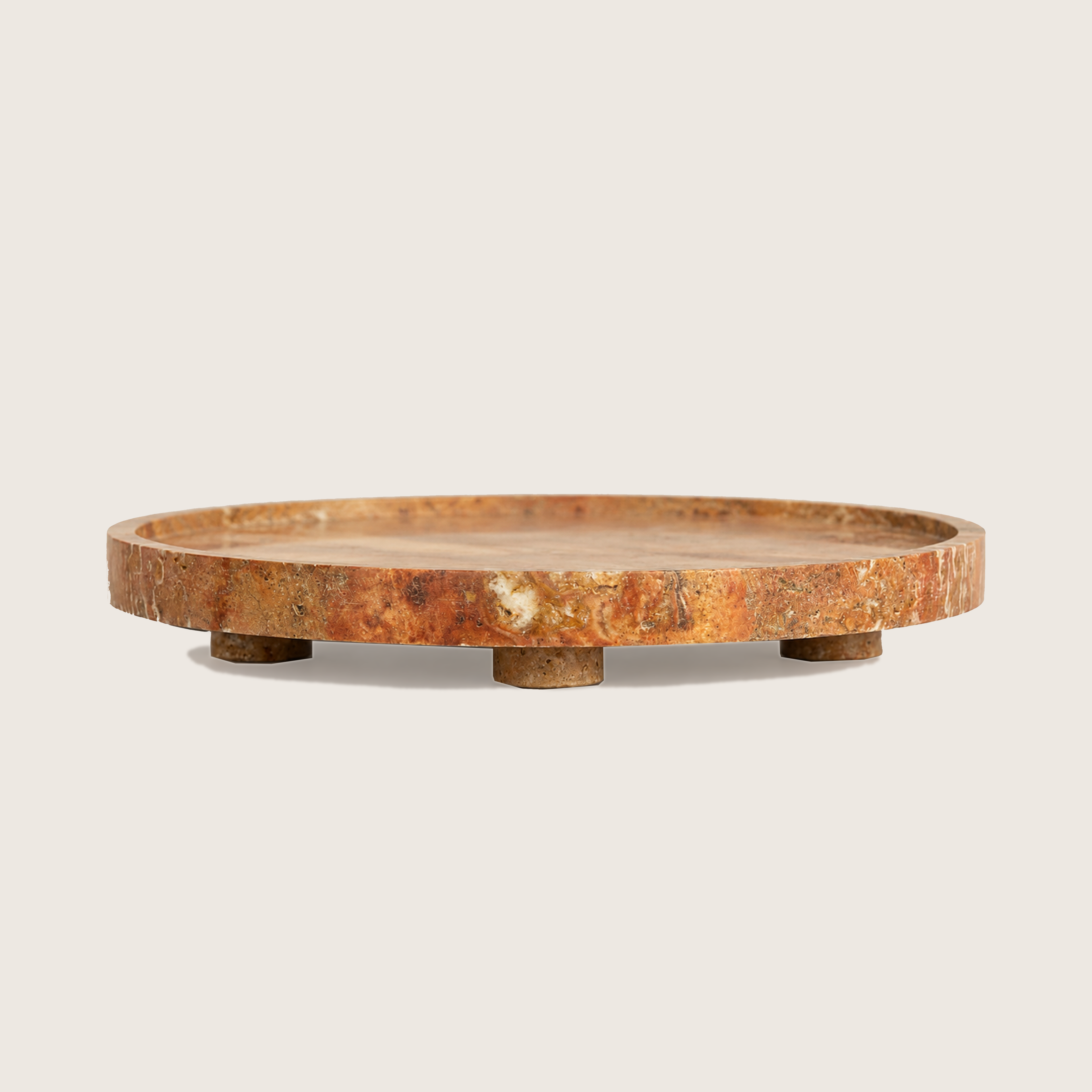Elevated red traventine marble serving plate on three rounded legs, defined by natural veining. 