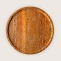 Elevated red traventine marble serving plate on three rounded legs, defined by natural veining. 